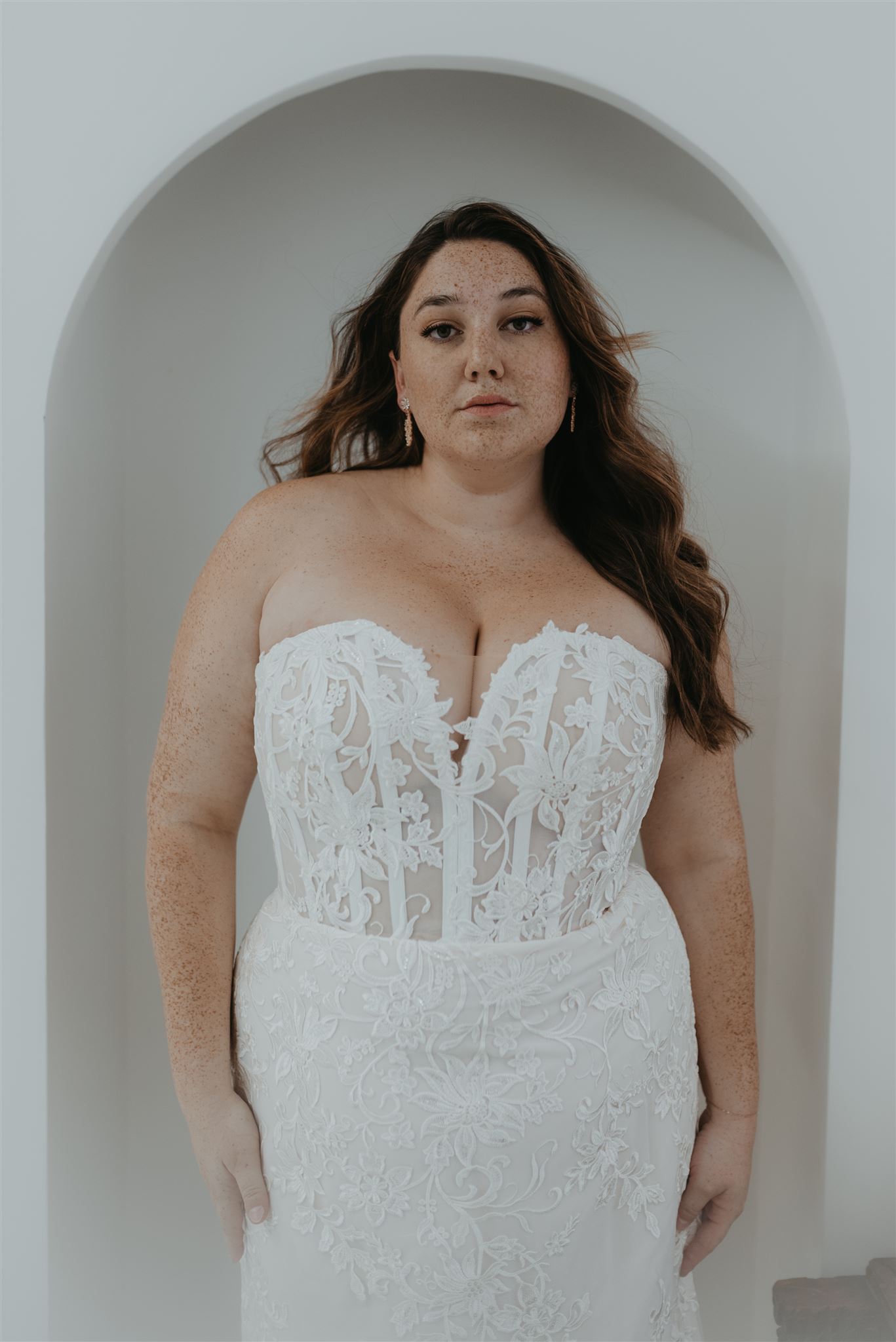 Beautiful wedding dress fitted on a plus size model with makeup and hair done by Beauty Trend